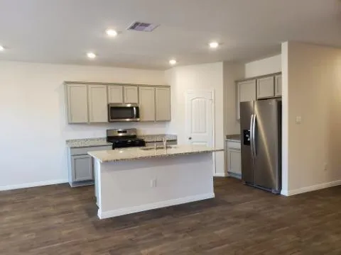 a kitchen with stainless steel appliances a refrigerator sink and microwave