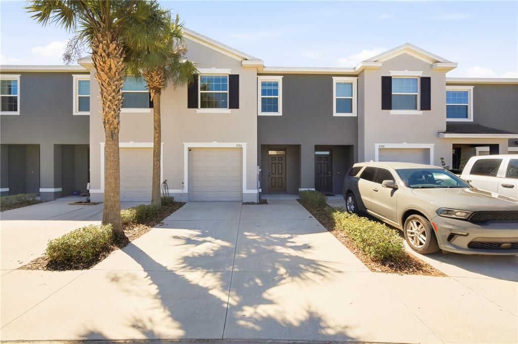 a front view of a house with parking space