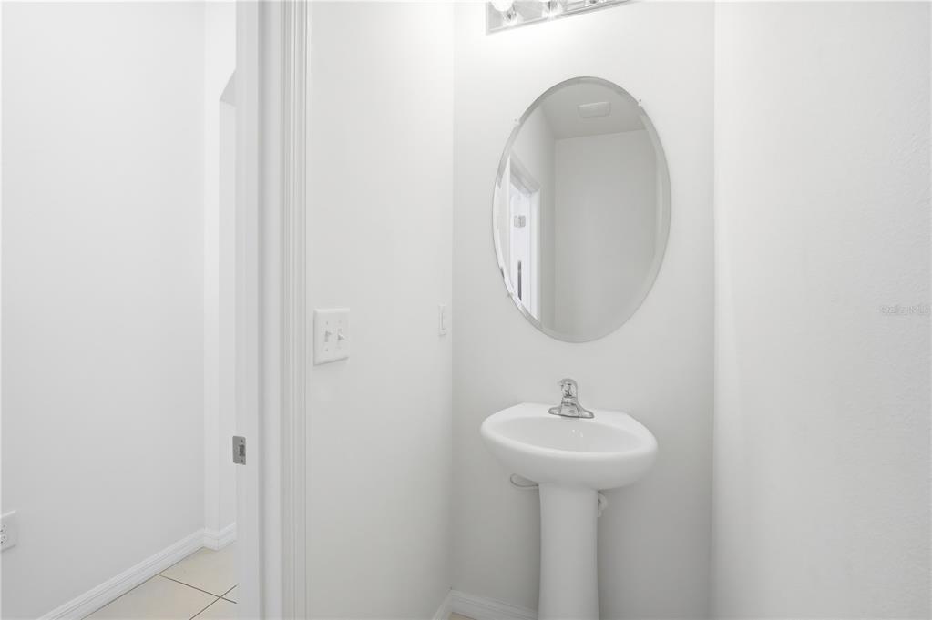 8986 Indigo Trail Loop Riverview, FL 33578 - Photo 6 of 28 a bathroom with a sink and a mirror