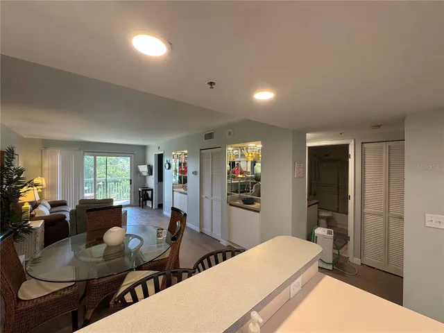 a living room with furniture a dining table and wooden floor