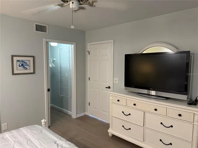 a living room with flat screen tv and dresser