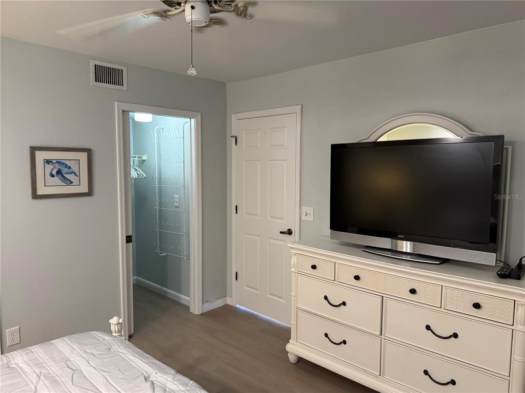 2320 Terra Ceia Bay Boulevard, Unit 404 Palmetto, FL 34221 - Photo 7 of 12 a living room with flat screen tv and dresser