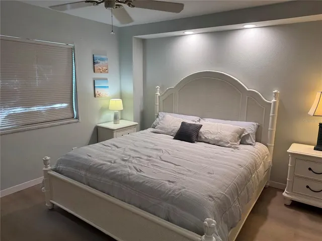 a large bed sitting in a bedroom next to a window