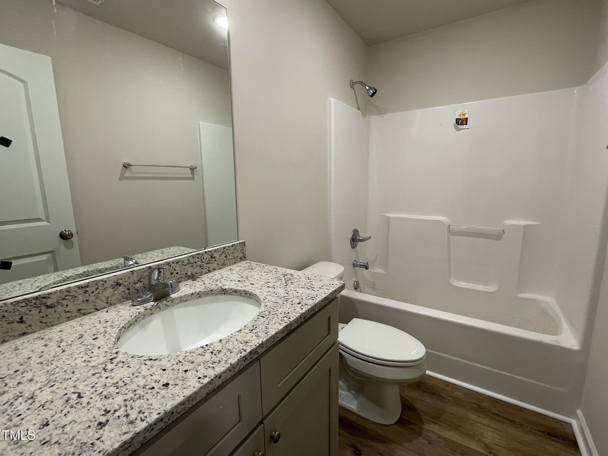 261 Phil Jack Road Dunn, NC 28334 - Photo 8 of 18 a bathroom with a granite countertop sink a toilet and a mirror