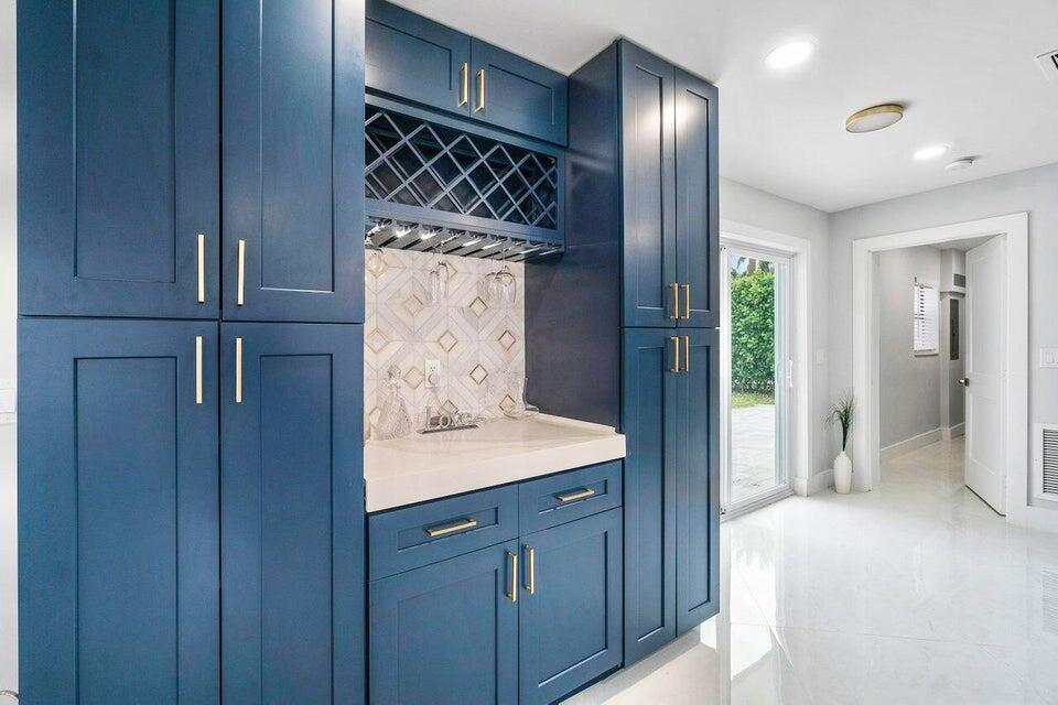 324 Bamboo Road Palm Beach Shores, FL 33404 - Photo 11 of 59 a kitchen with a refrigerator and cabinets