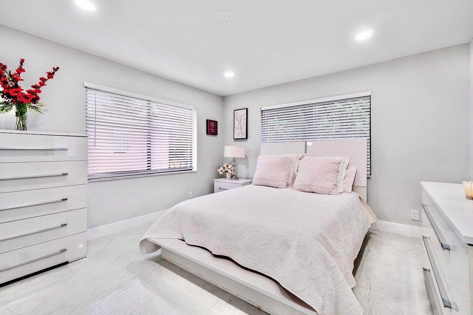 324 Bamboo Road Palm Beach Shores, FL 33404 - Photo 24 of 59 a bedroom with a bed and a window