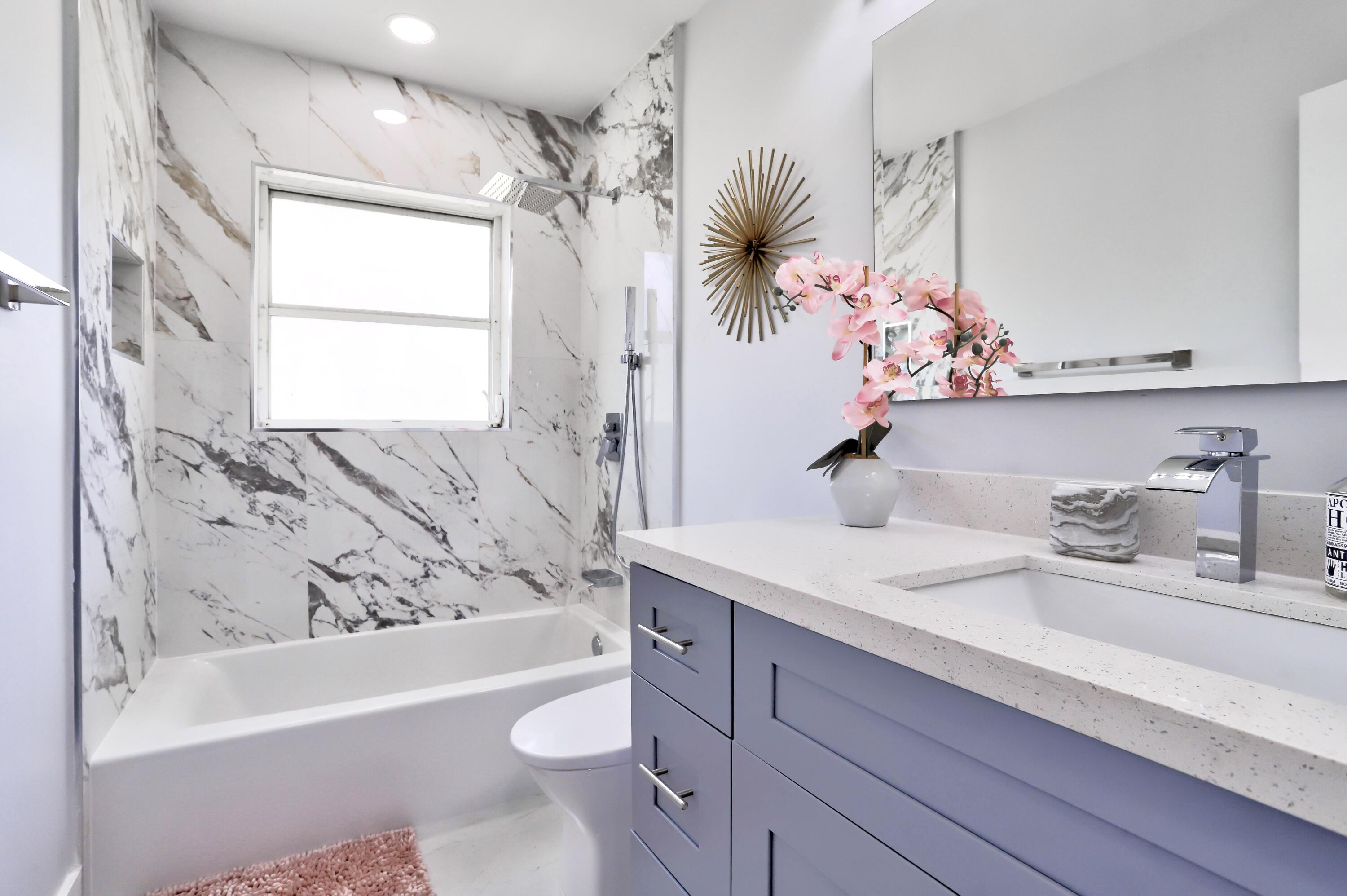 324 Bamboo Road Palm Beach Shores, FL 33404 - Photo 33 of 59 a bathroom with a bathtub sink and mirror
