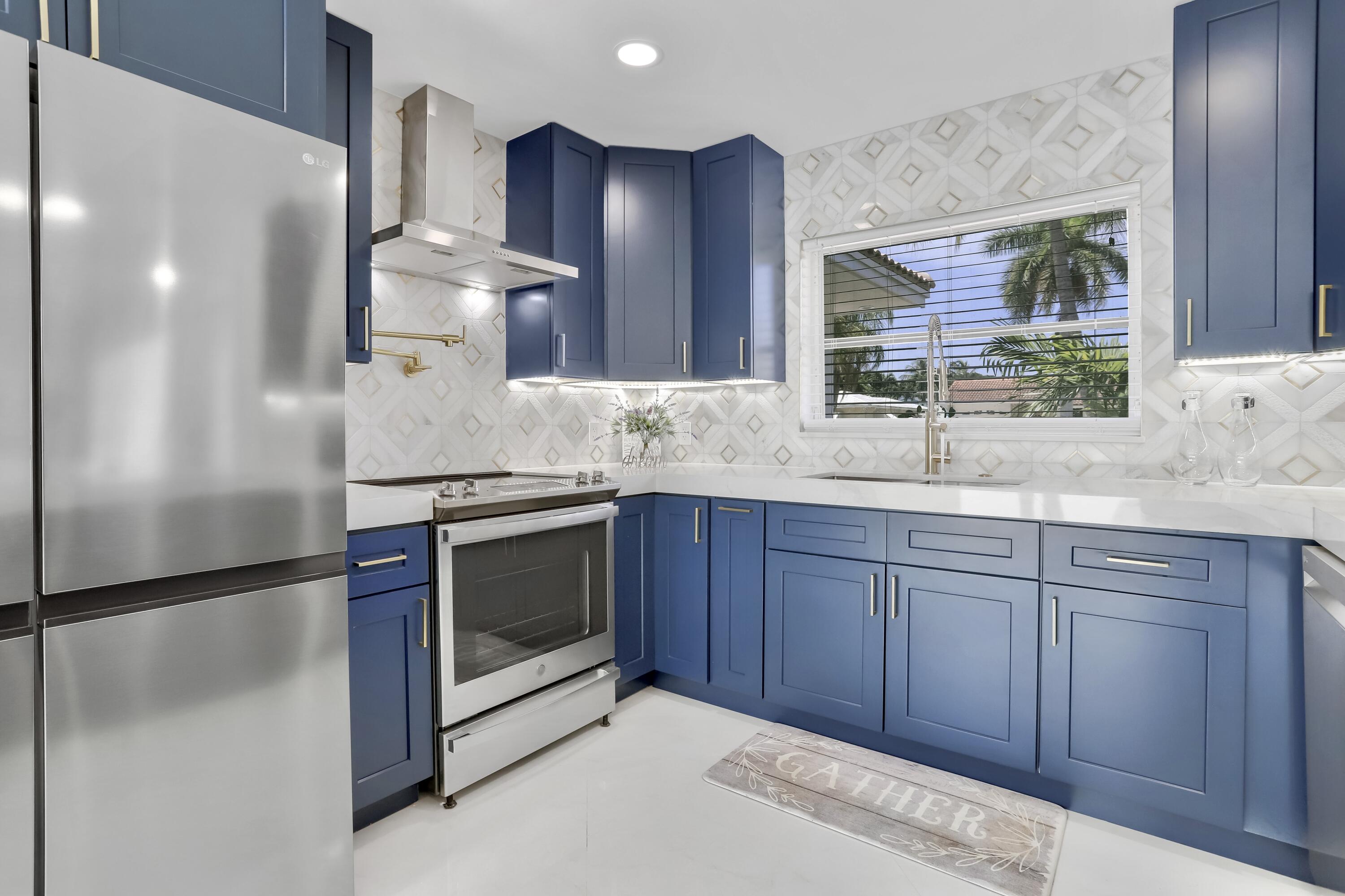 324 Bamboo Road Palm Beach Shores, FL 33404 - Photo 41 of 59 a kitchen with stainless steel appliances granite countertop a refrigerator and a sink