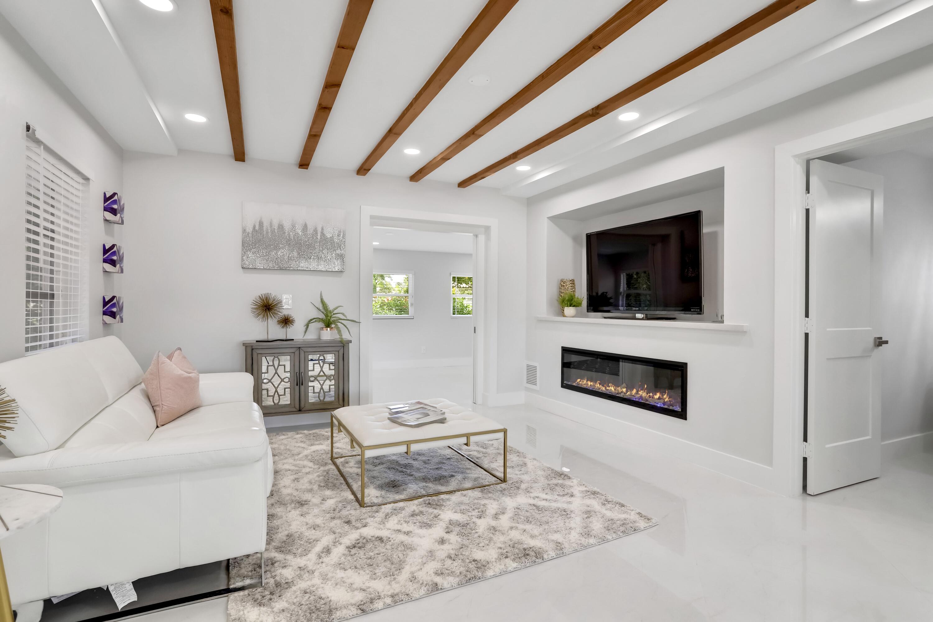 324 Bamboo Road Palm Beach Shores, FL 33404 - Photo 43 of 59 a living room with furniture and a fireplace