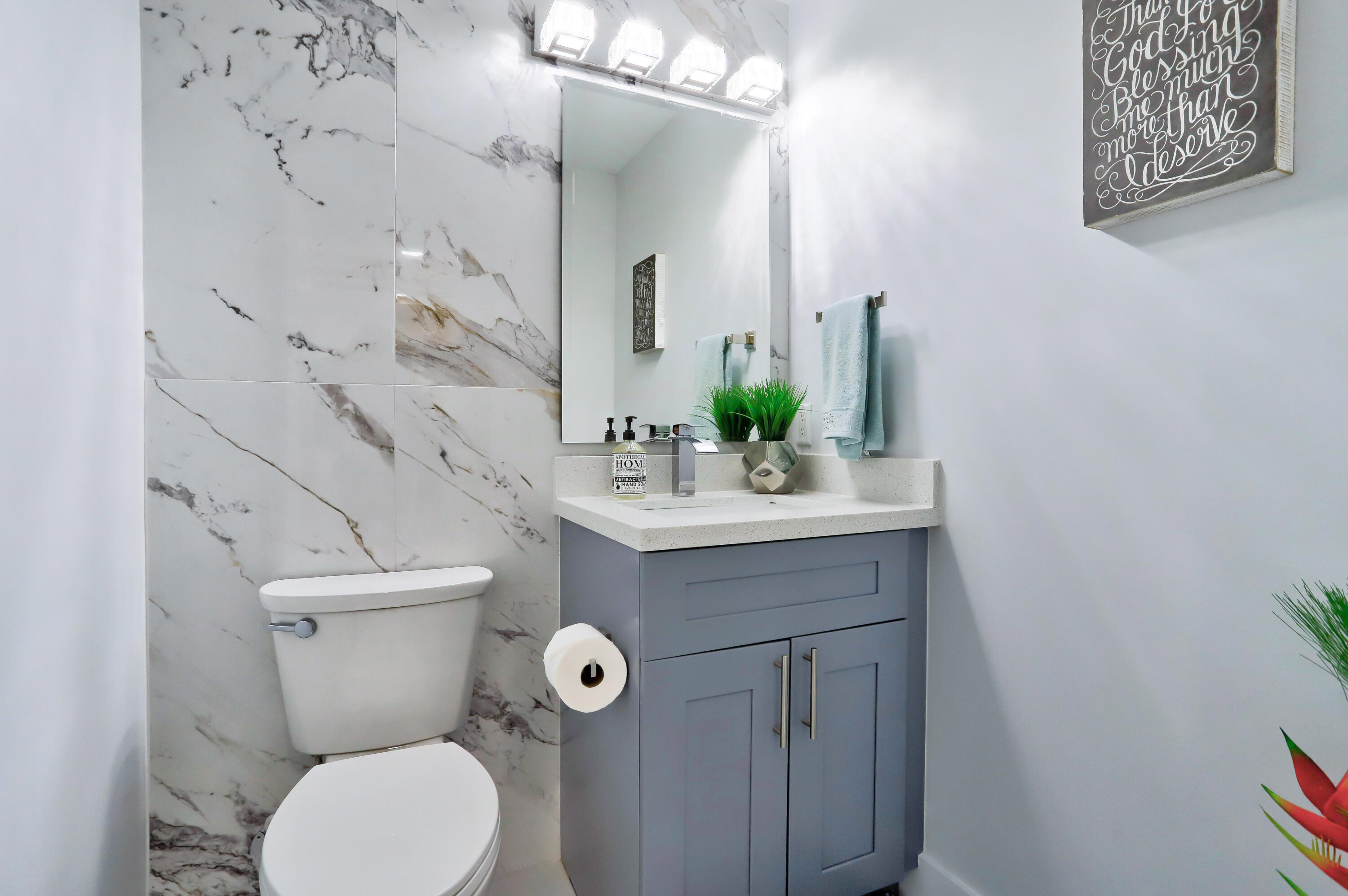 324 Bamboo Road Palm Beach Shores, FL 33404 - Photo 45 of 59 a bathroom with a sink mirror vanity and toilet