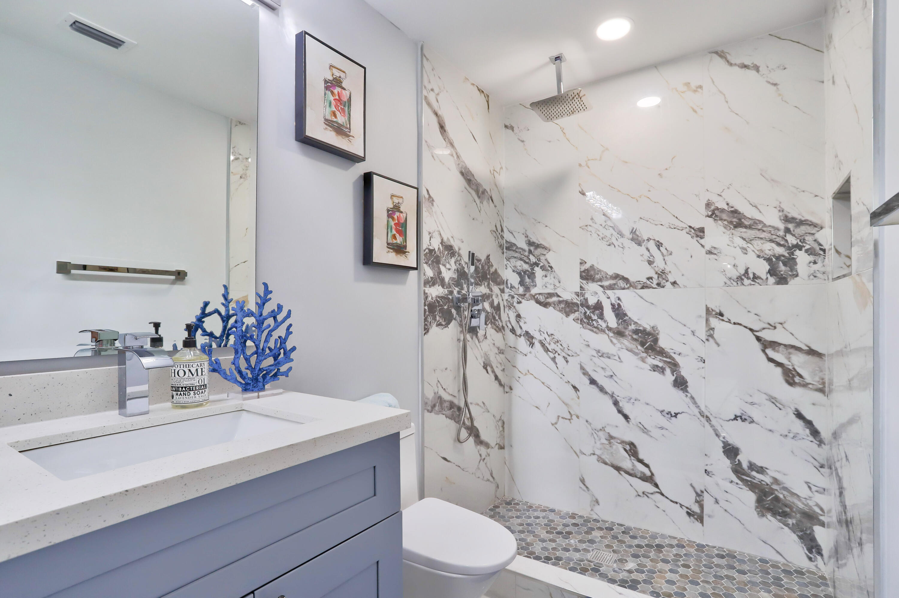 324 Bamboo Road Palm Beach Shores, FL 33404 - Photo 46 of 59 a bathroom with a sink toilet and shower