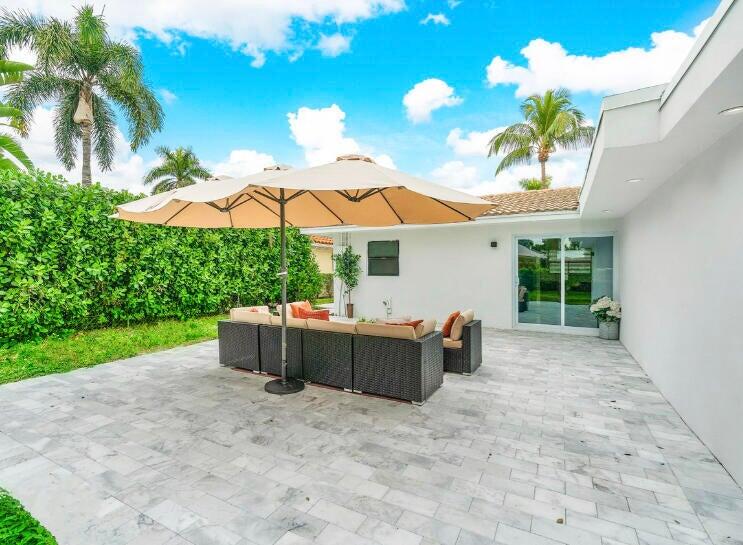 324 Bamboo Road Palm Beach Shores, FL 33404 - Photo 5 of 59 a view of a house with patio and wooden floor