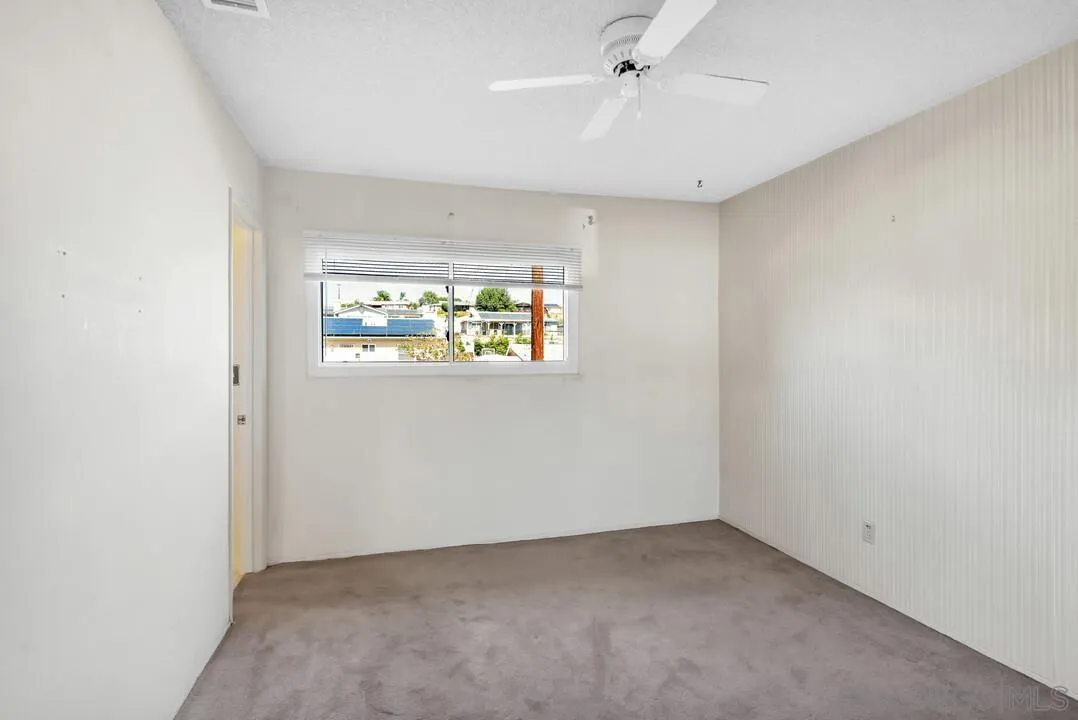 9517 Abbeyfield Road Santee, CA 92071 - Photo 23 of 42 an empty room with a window and a ceiling fan