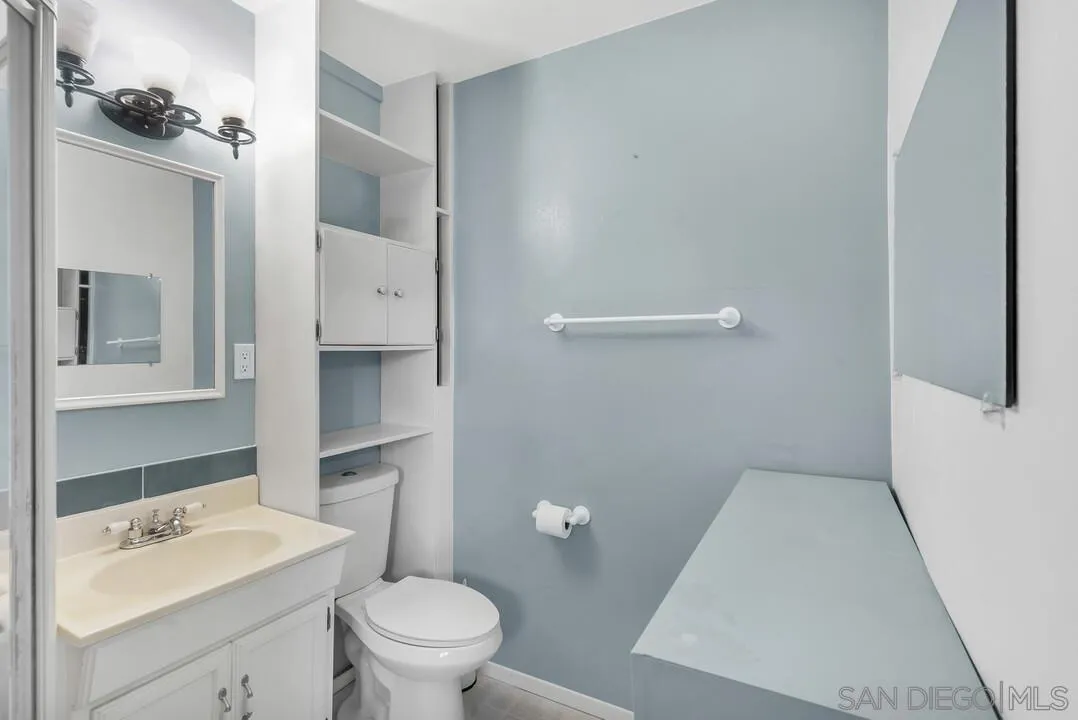 9517 Abbeyfield Road Santee, CA 92071 - Photo 26 of 42 a bathroom with a sink a toilet and a mirror