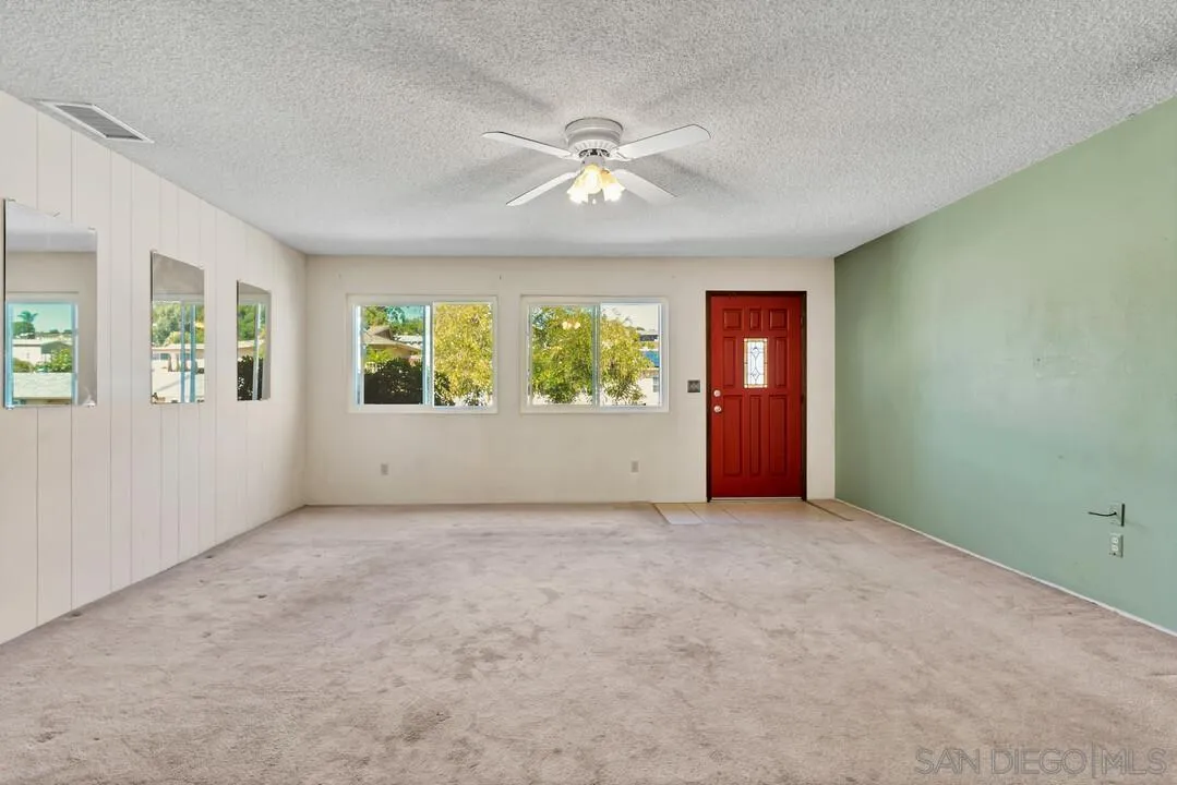 9517 Abbeyfield Road Santee, CA 92071 - Photo 5 of 42 an empty room with windows and ceiling fan