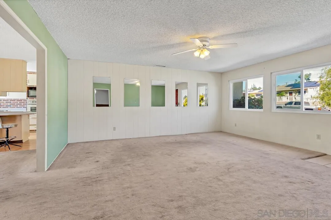 9517 Abbeyfield Road Santee, CA 92071 - Photo 6 of 42 an empty room with windows and ceiling fan
