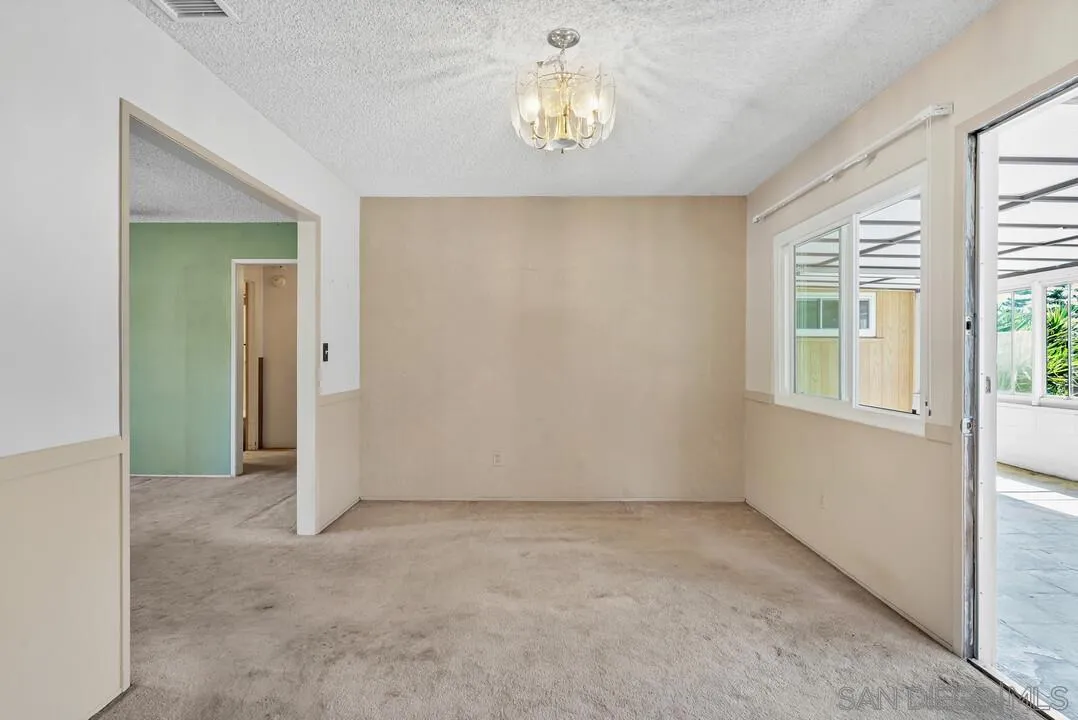 9517 Abbeyfield Road Santee, CA 92071 - Photo 8 of 42 en empty room with windows and chandelier