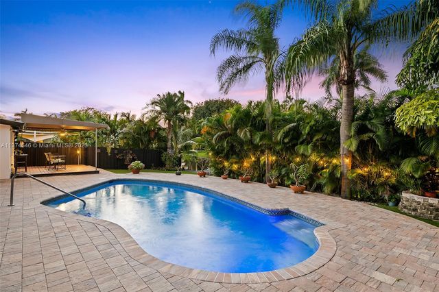 a view of a swimming pool with an outdoor seating