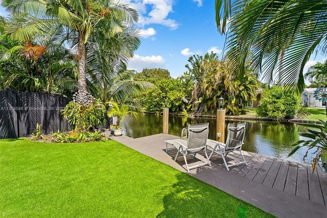 a view of a lake with a table and chairs
