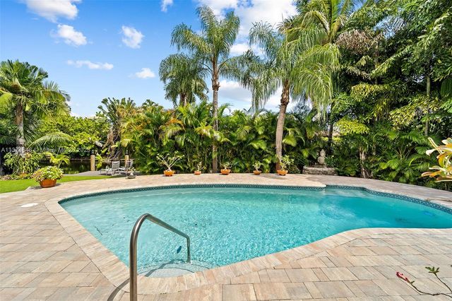a view of swimming pool from a garden
