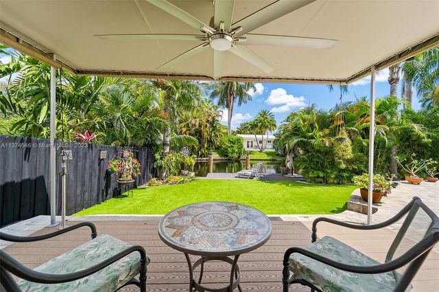 a view of a patio with a yard table and chairs