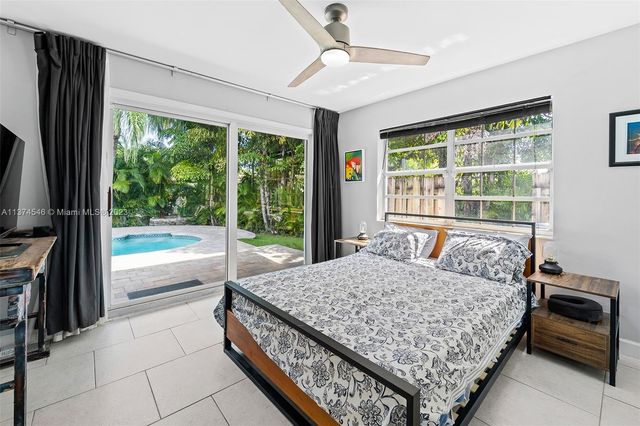 a bedroom with a large bed and a large window