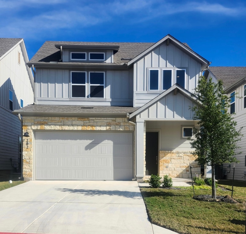 320 Creek Road, Unit 202 Dripping Springs, TX 78620 - Photo 1 of 26 a front view of a house with garden