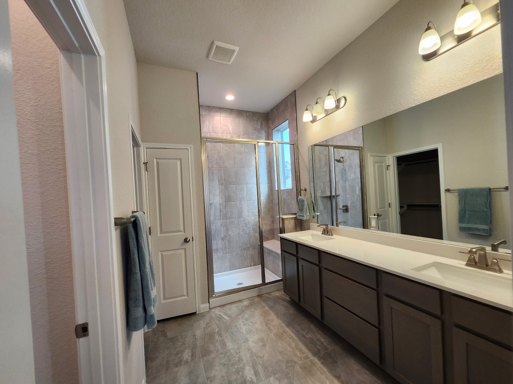 320 Creek Road, Unit 202 Dripping Springs, TX 78620 - Photo 12 of 26 a spacious bathroom with a double vanity sink shower and mirror
