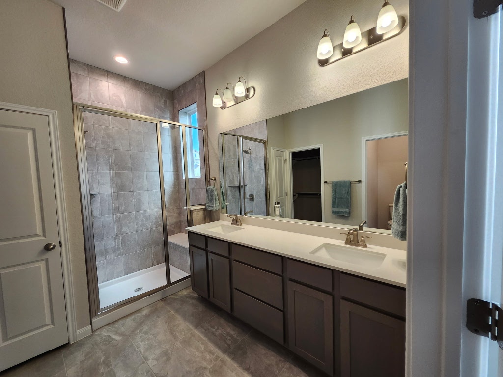 320 Creek Road, Unit 202 Dripping Springs, TX 78620 - Photo 13 of 26 a bathroom with a double vanity sink mirror and shower