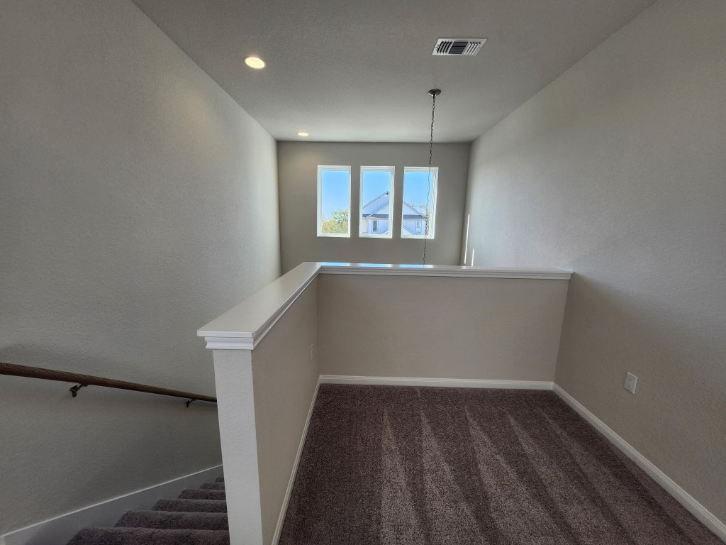 320 Creek Road, Unit 202 Dripping Springs, TX 78620 - Photo 14 of 26 a view of an empty room with wooden floor and a window