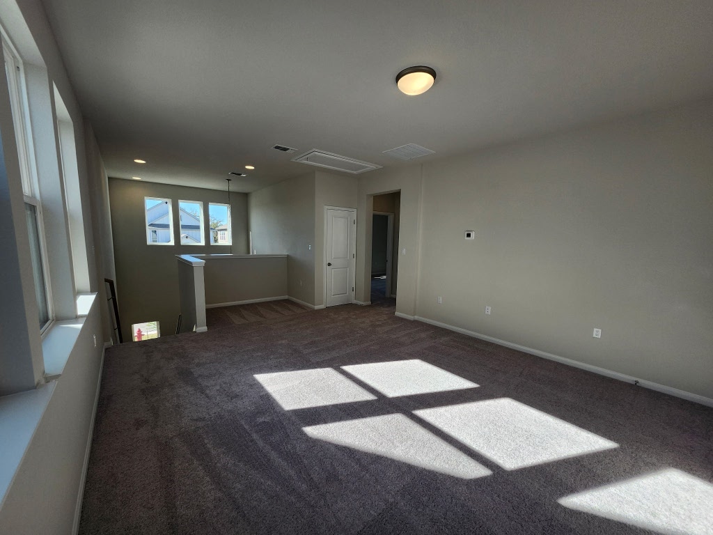 320 Creek Road, Unit 202 Dripping Springs, TX 78620 - Photo 15 of 26 wooden floor in an empty room with a window