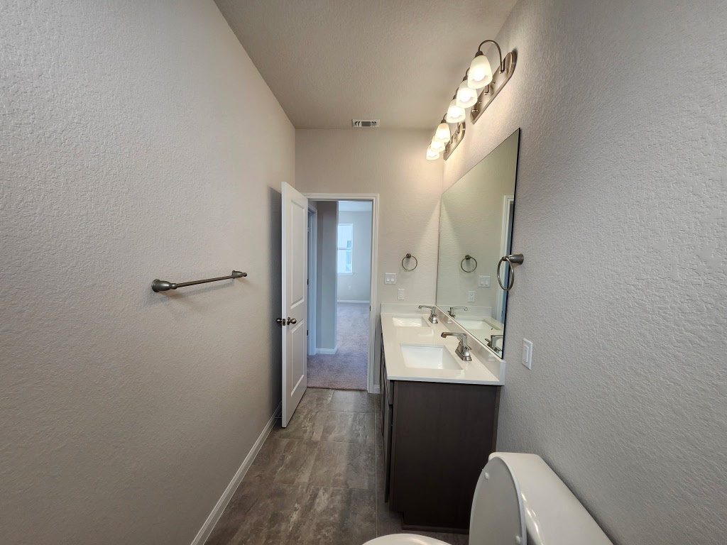 320 Creek Road, Unit 202 Dripping Springs, TX 78620 - Photo 17 of 26 a bathroom with a sink double vanity and a mirror