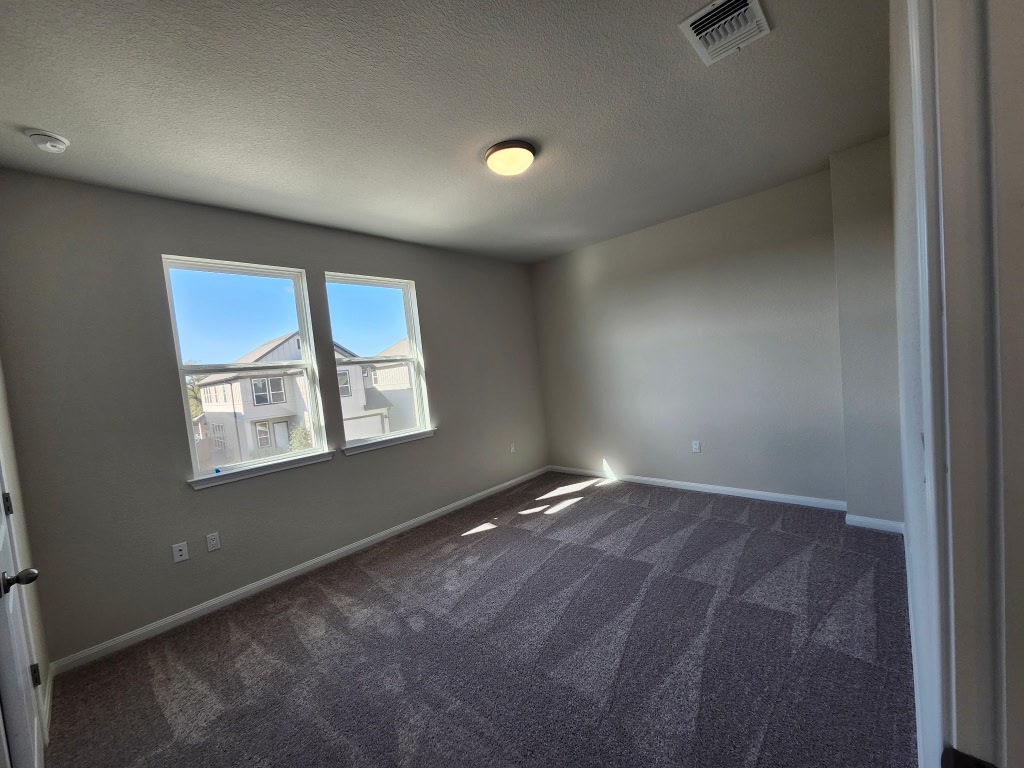 320 Creek Road, Unit 202 Dripping Springs, TX 78620 - Photo 18 of 26 an empty room with windows