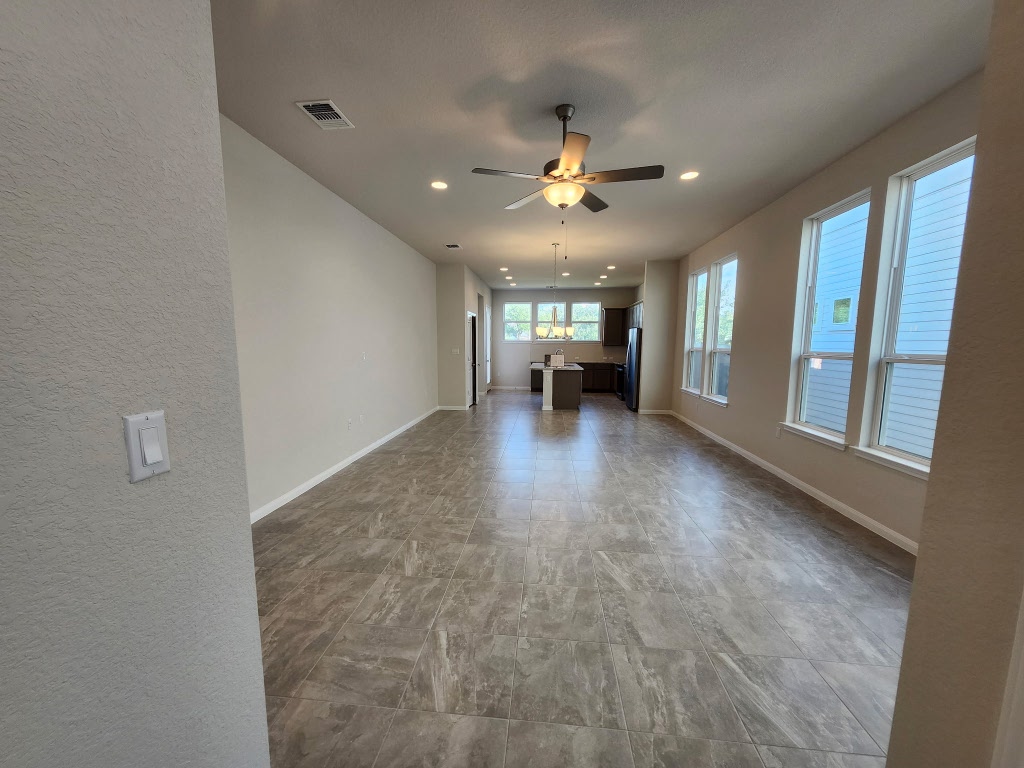 320 Creek Road, Unit 202 Dripping Springs, TX 78620 - Photo 2 of 26 a view of an empty room with window and cabinet