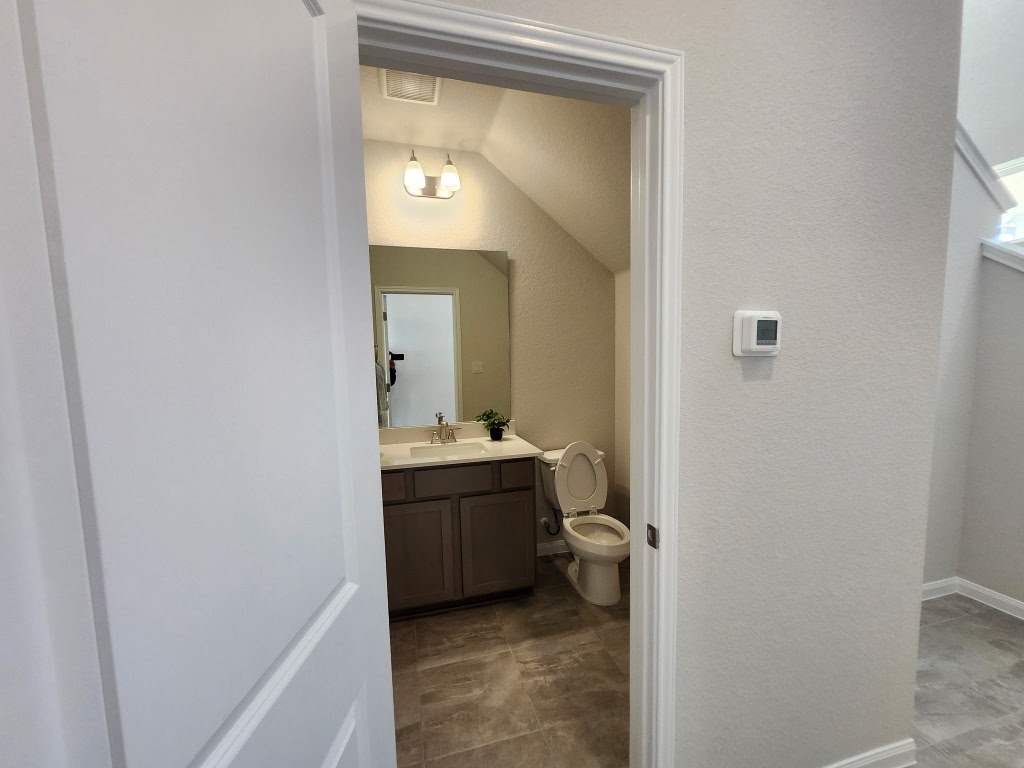 320 Creek Road, Unit 202 Dripping Springs, TX 78620 - Photo 21 of 26 a bathroom with a granite countertop sink and a mirror
