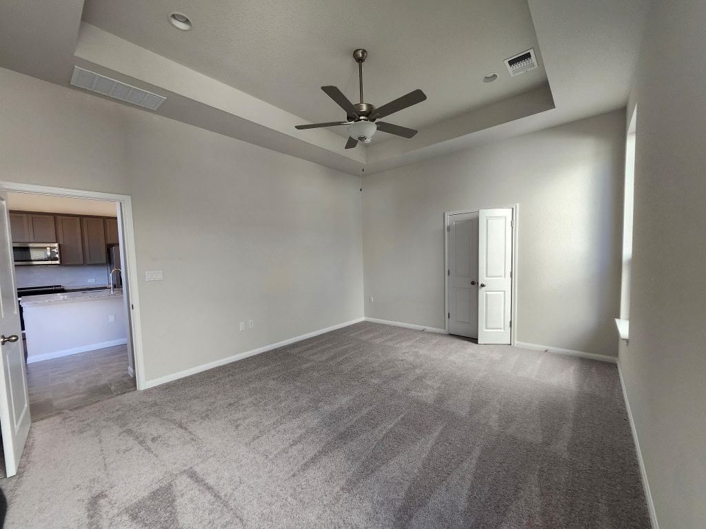 320 Creek Road, Unit 202 Dripping Springs, TX 78620 - Photo 24 of 26 an empty room with fan and entrance