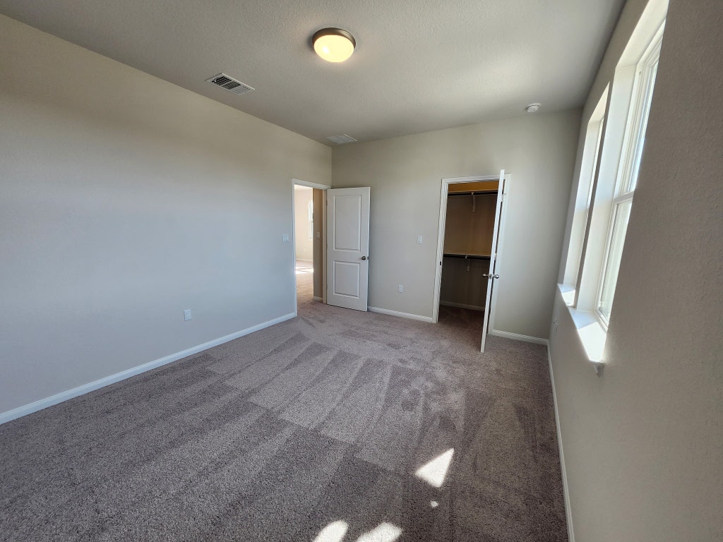 320 Creek Road, Unit 202 Dripping Springs, TX 78620 - Photo 10 of 26 an empty room with a window and a bathroom
