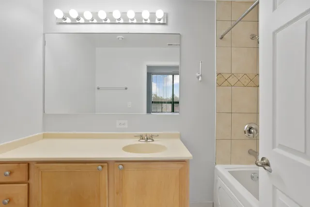 a bathroom with a sink a vanity and a mirror