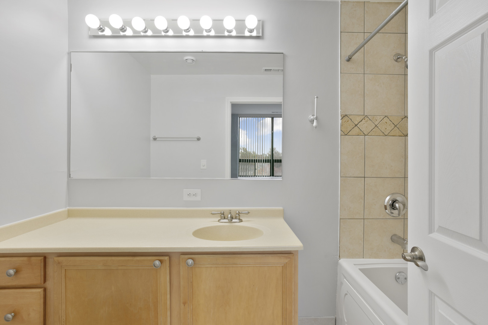 2451 West Howard Street, Unit 401 Chicago, IL 60645 - Photo 11 of 14 a bathroom with a sink a vanity and a mirror