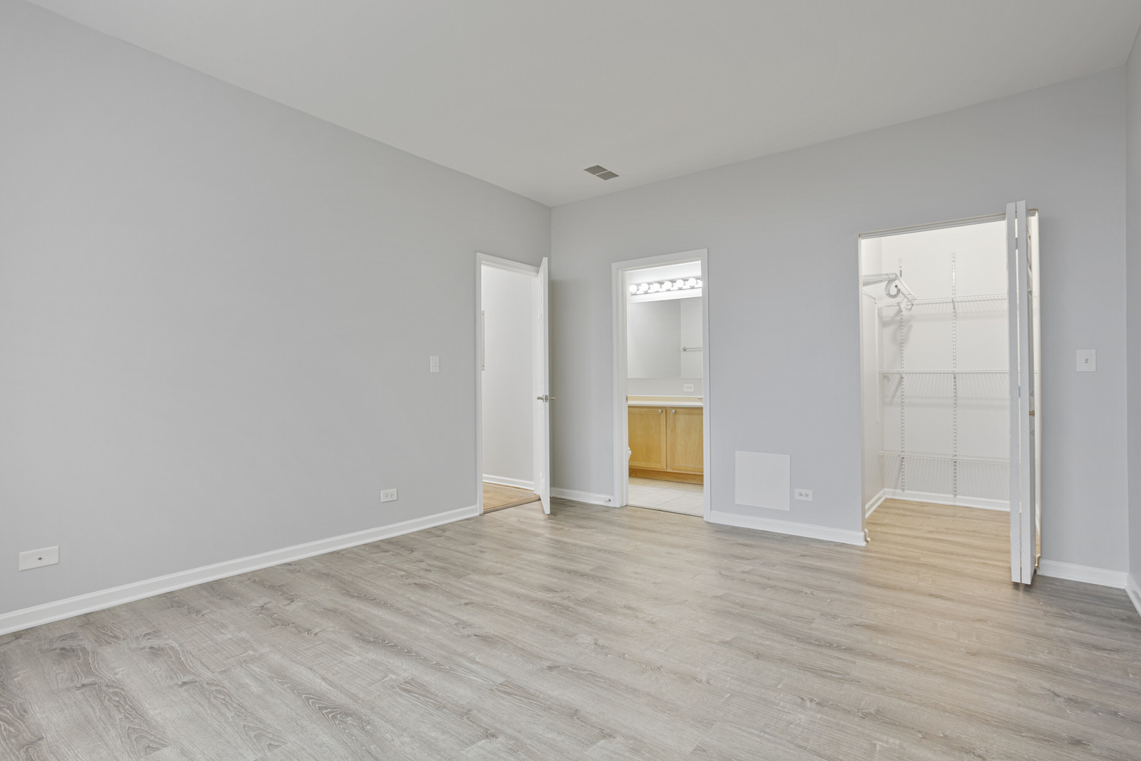 2451 West Howard Street, Unit 401 Chicago, IL 60645 - Photo 8 of 14 a view of an empty room with wooden floor and a window