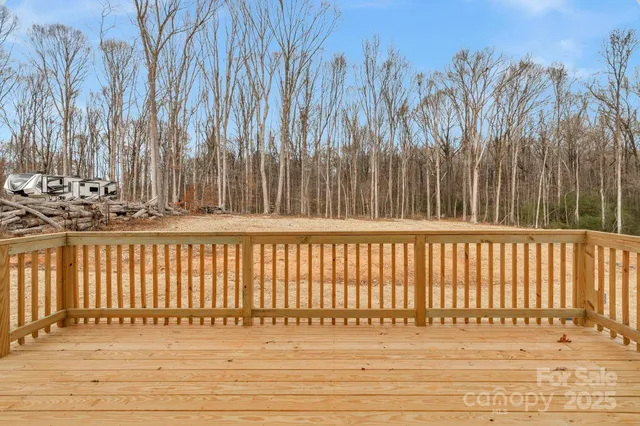 a view of house with backyard and trees