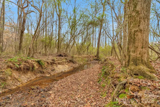 a view of a house with snow on the roadside
