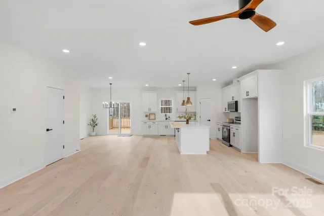 a view of a kitchen with a sink and cabinets