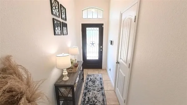 a view of a hallway with wooden floor and a hallway