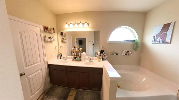 a en suite bathroom with a sink a large mirror and a shower