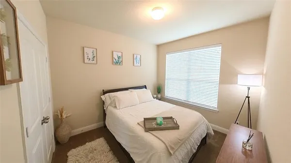 a bedroom with a bed and a window