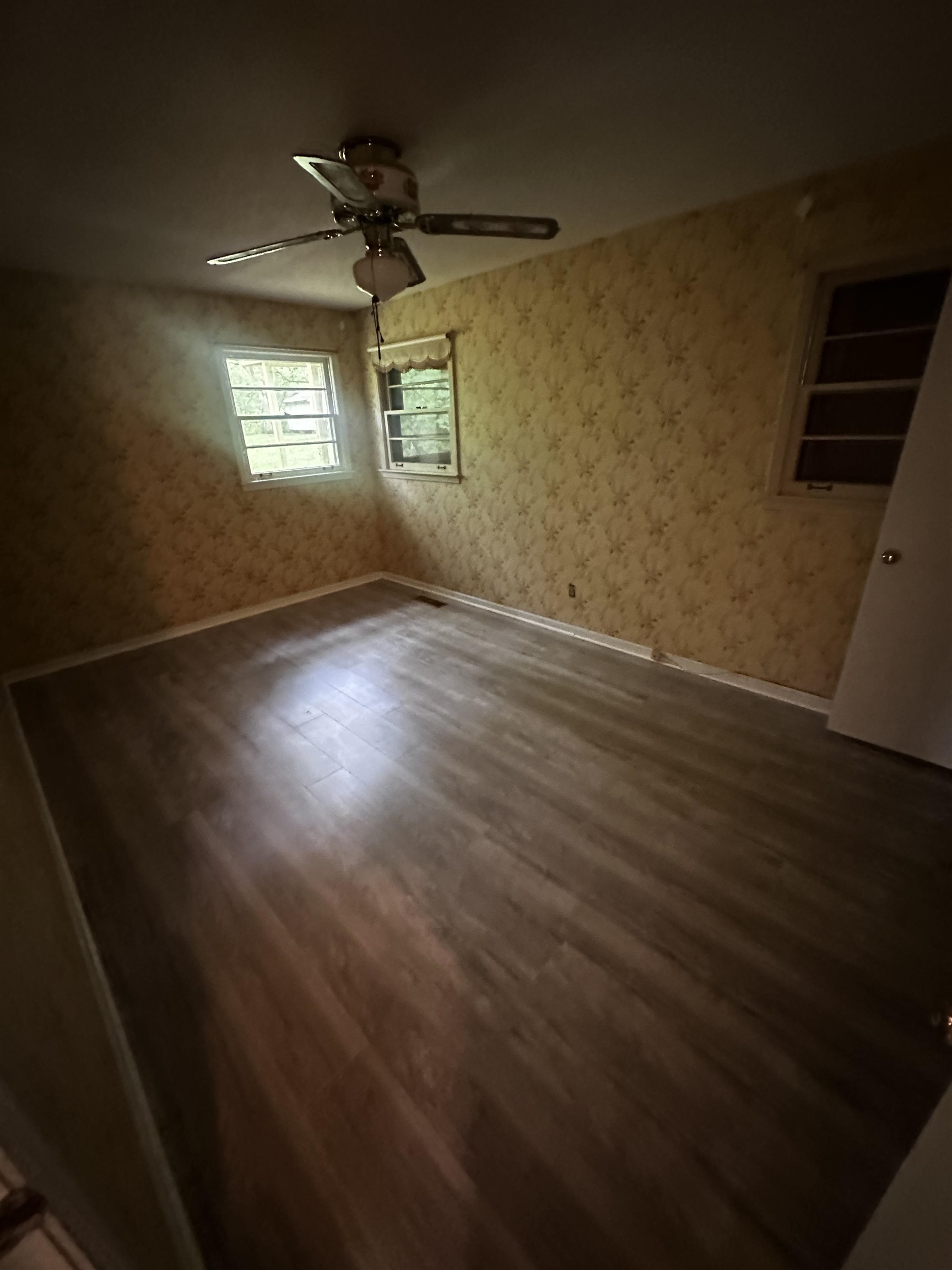 1865 Bartlett Road Memphis, TN 38134 - Photo 5 of 26 an empty room with wooden floor and windows
