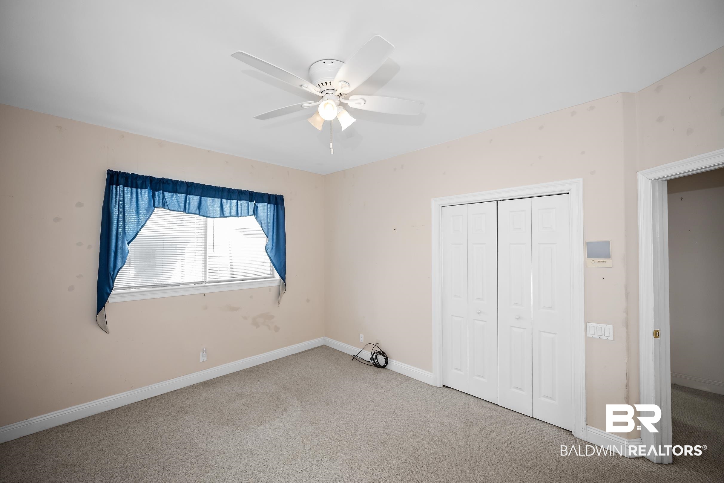 8591 Bay Harbor Road Elberta, AL 36530 - Photo 40 of 56 Unfurnished bedroom with carpet, a ceiling fan, and a closet