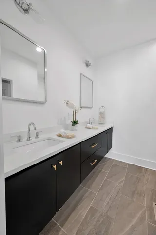 a spacious bathroom with a double vanity sink and a mirror