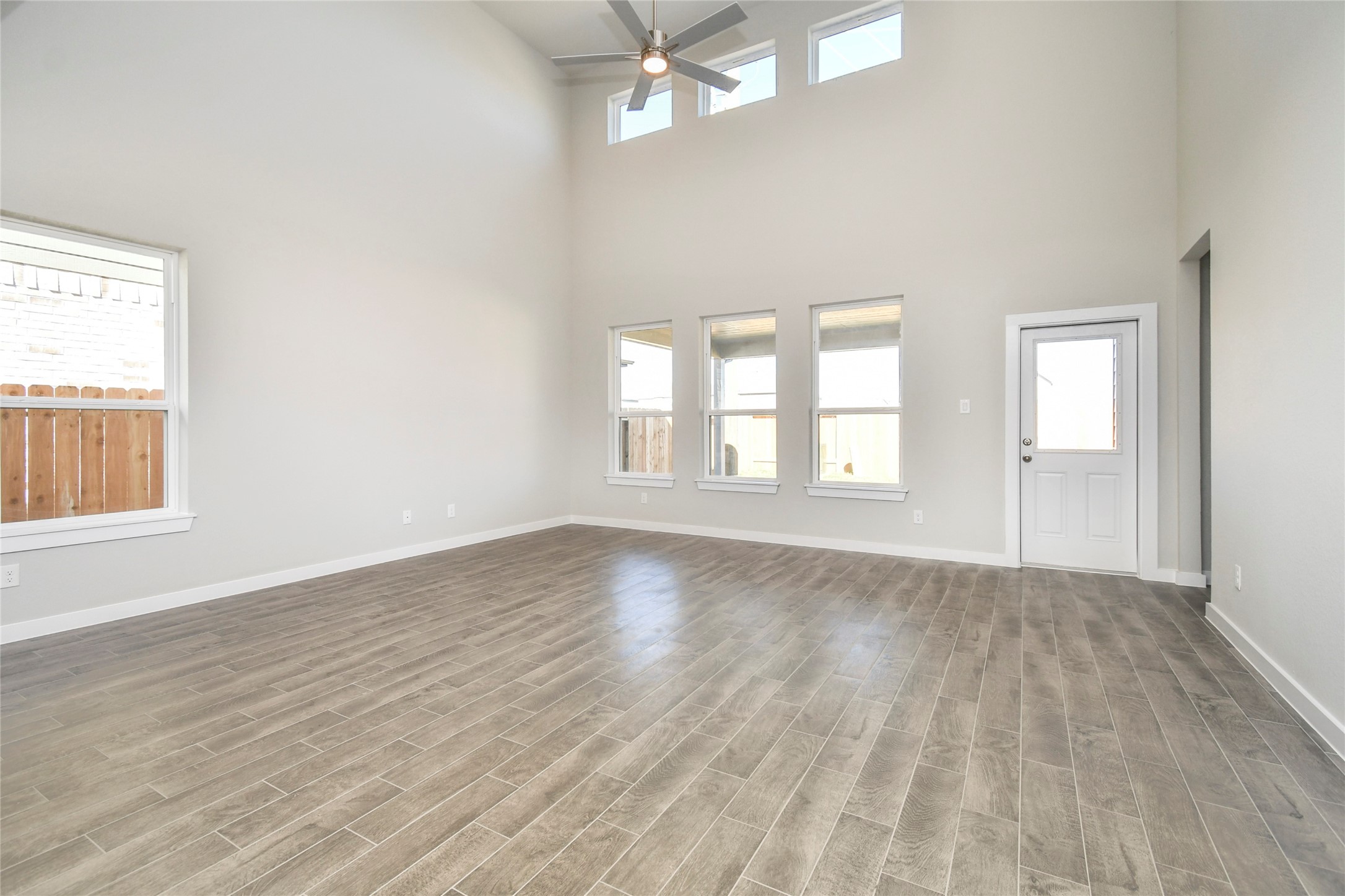 15111 Statice Trail Houston, TX 77044 - Photo 18 of 35 wooden floor in an empty room with a window